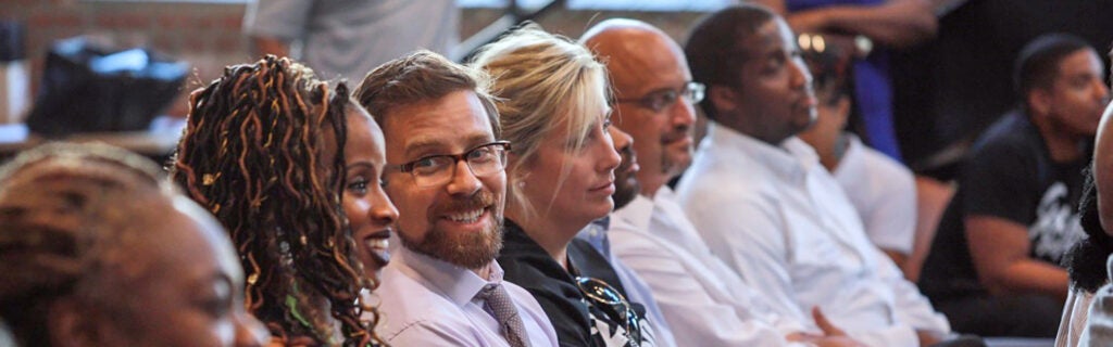 Group of adults sitting in a row