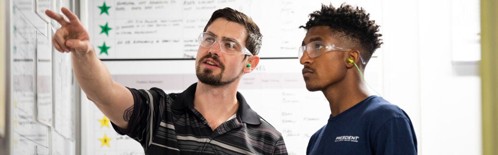 Two men learning at whiteboard