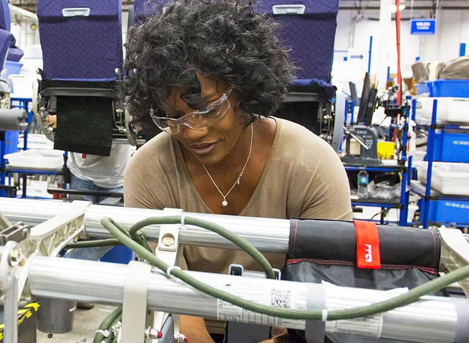 Woman using machine with safety goggles